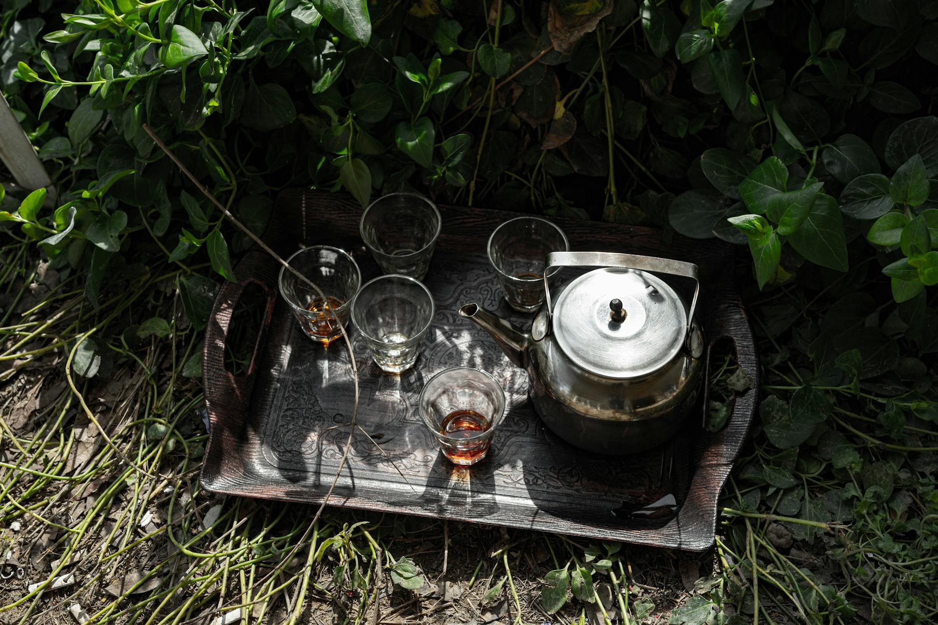 Styled tea glasses with reflective surfaces and layered linens
